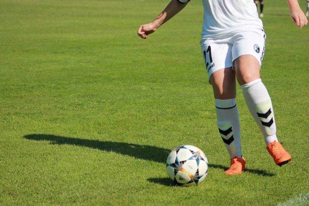 Soccer player dribbling the ball.