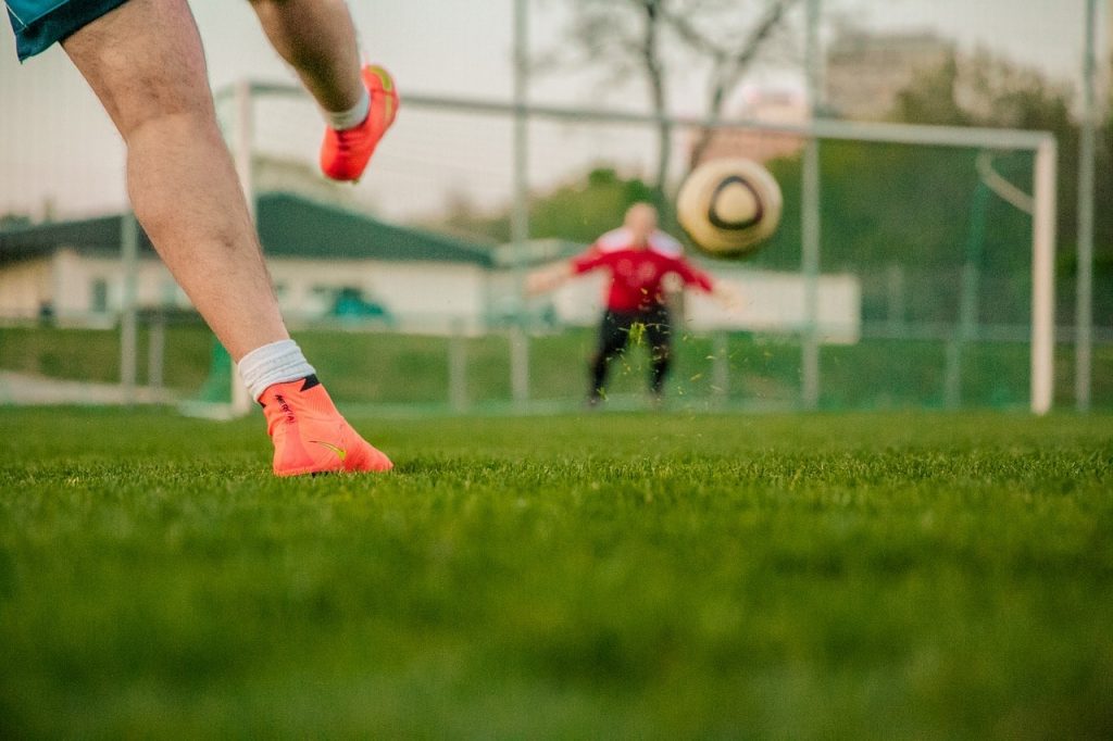 Soccer player training with a full-size goal.