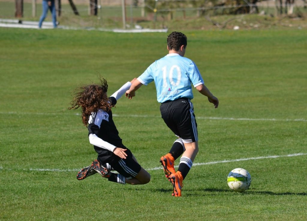 Soccer player making a slide tackle.